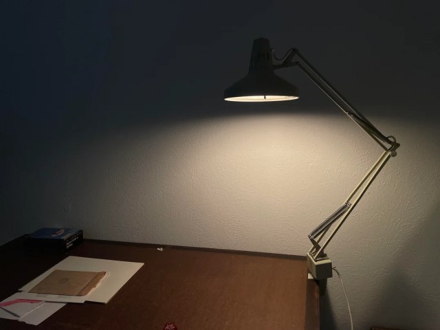 A Luxo Color Correct Lamp on a desk lights up an office space.