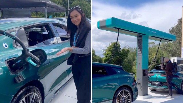 A woman showcases an electric vehicle fast charger.
