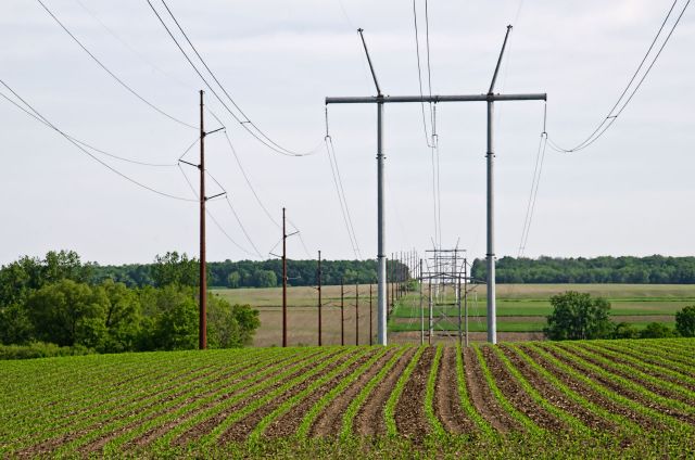 Power lines stretching over agricultural fields.