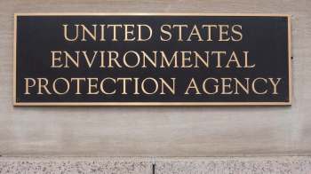 A bronze plaque displaying the words "United States Environmental Protection Agency" mounted on a stone wall.