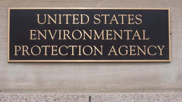 A bronze plaque displaying the words "United States Environmental Protection Agency" mounted on a stone wall.