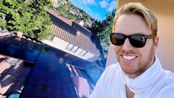 An illustration with someone's face in the foreground and a roof with solar panels in the background.