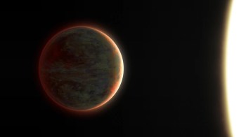 A planet illuminated by a star against the darkness of space.