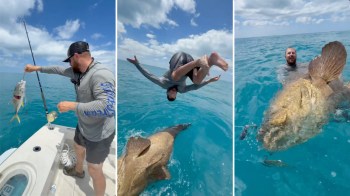 A man baits a fishing rod, flips into the water, and swims next to a large fish.