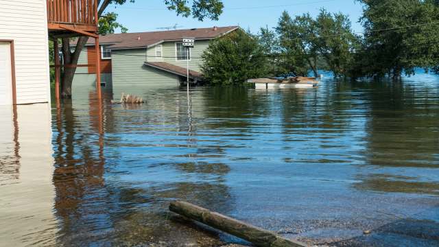 Several houses in a flooded street.