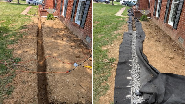 A progress view of a drainage trench being prepared with a pipe and gravel.