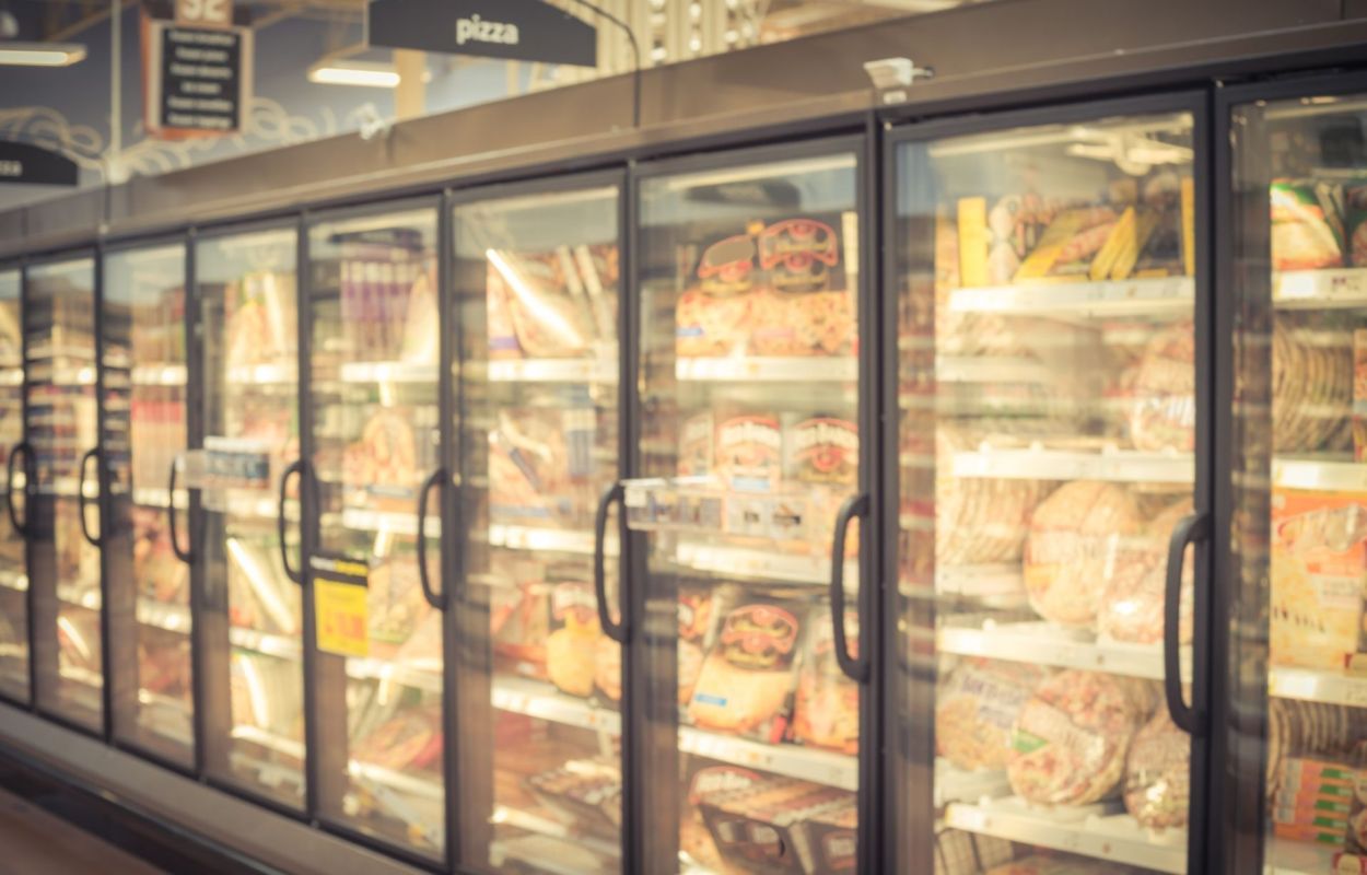 Frozen pizza and bread in a grocery store.