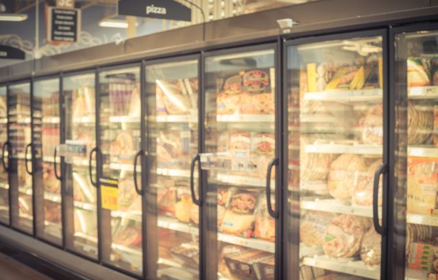 Frozen pizza and bread in a grocery store.
