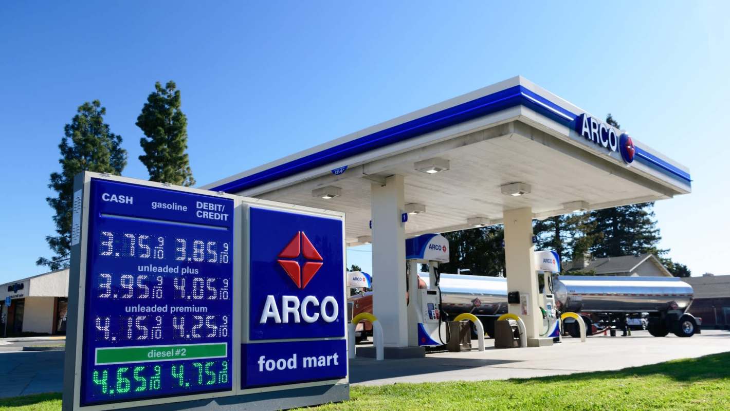 An Arco gas station sign displays fuel prices starting at under $4 per gallon.