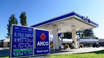 An Arco gas station sign displays fuel prices starting at under $4 per gallon.