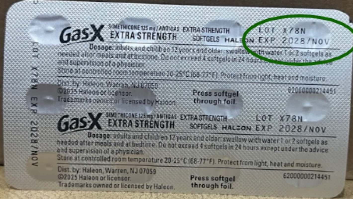 A packet of Gas-X extra strength softgels with dosage instructions and expiration date clearly visible.