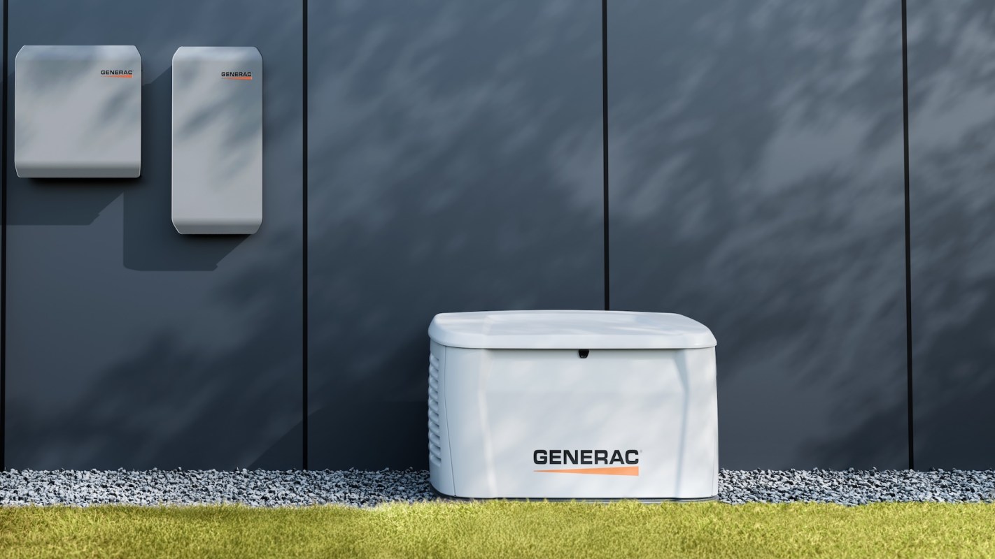 A white Generac backup generator and two wall-mounted battery units against a dark wall.