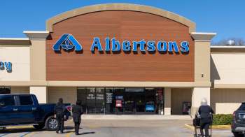 The storefront of an Albertsons grocery store with customers approaching the entrance.