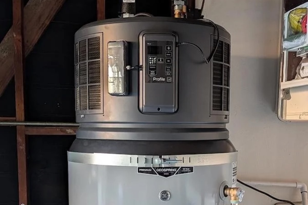 A gray-and-black heat pump water heater.