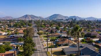 Aerial view of a suburban neighborhood with mountains in the background.