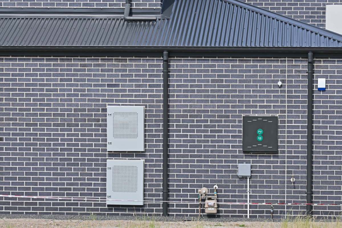 Residential battery storage units installed on an exterior wall.