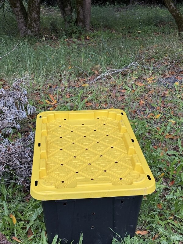 A big plastic container used for composting.