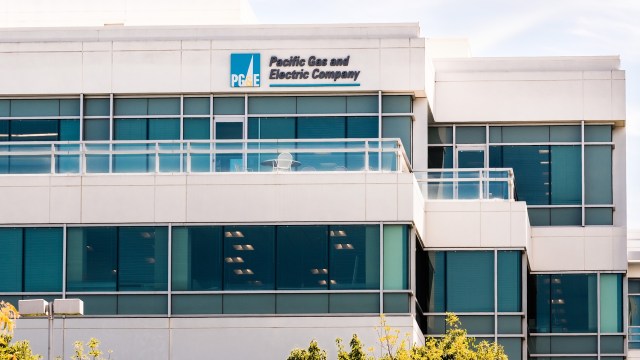Modern office building with glass windows and a sign for Pacific Gas and Electric Company.