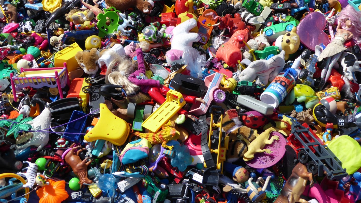 A colorful assortment of various toys scattered together in a disorganized pile.