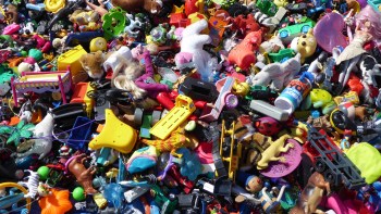 A colorful assortment of various toys scattered together in a disorganized pile.