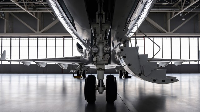 A front view of a private jet in a hangar.