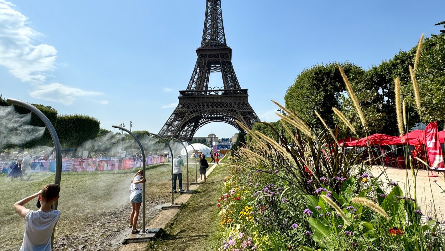 People cool off under misting stations near the Eiffel Tower.