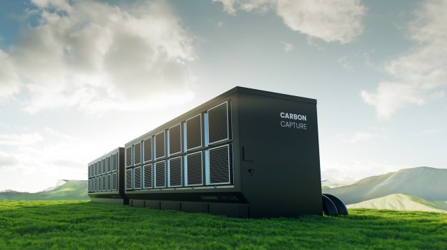 A large carbon capture facility sits in a green landscape under a cloudy sky.