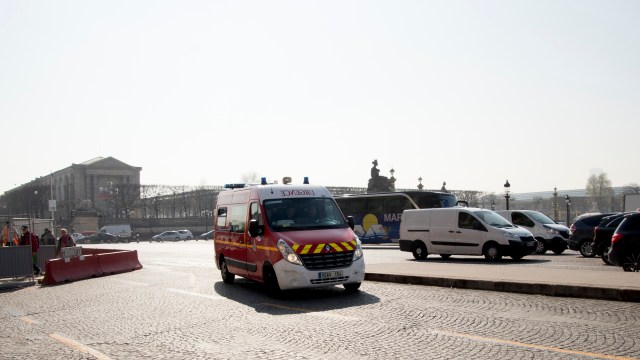 An ambulance drives through a city street.