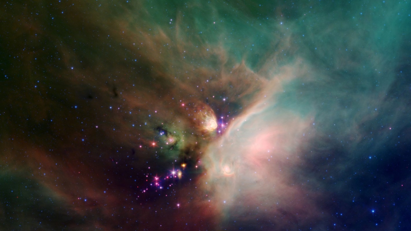 A colorful nebula filled with bright stars and swirling cosmic clouds in deep space.