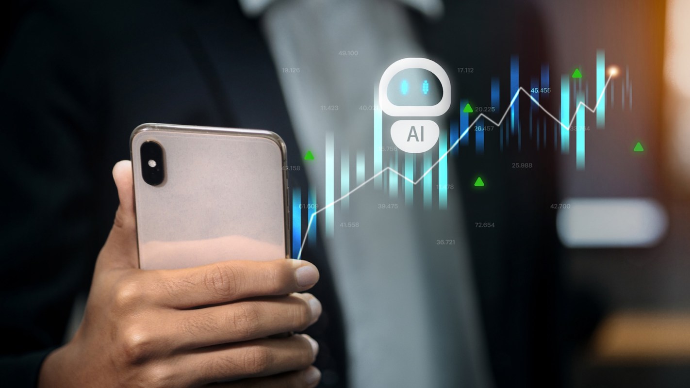 A person holding a smartphone with digital graphs and an AI icon superimposed in a business setting.