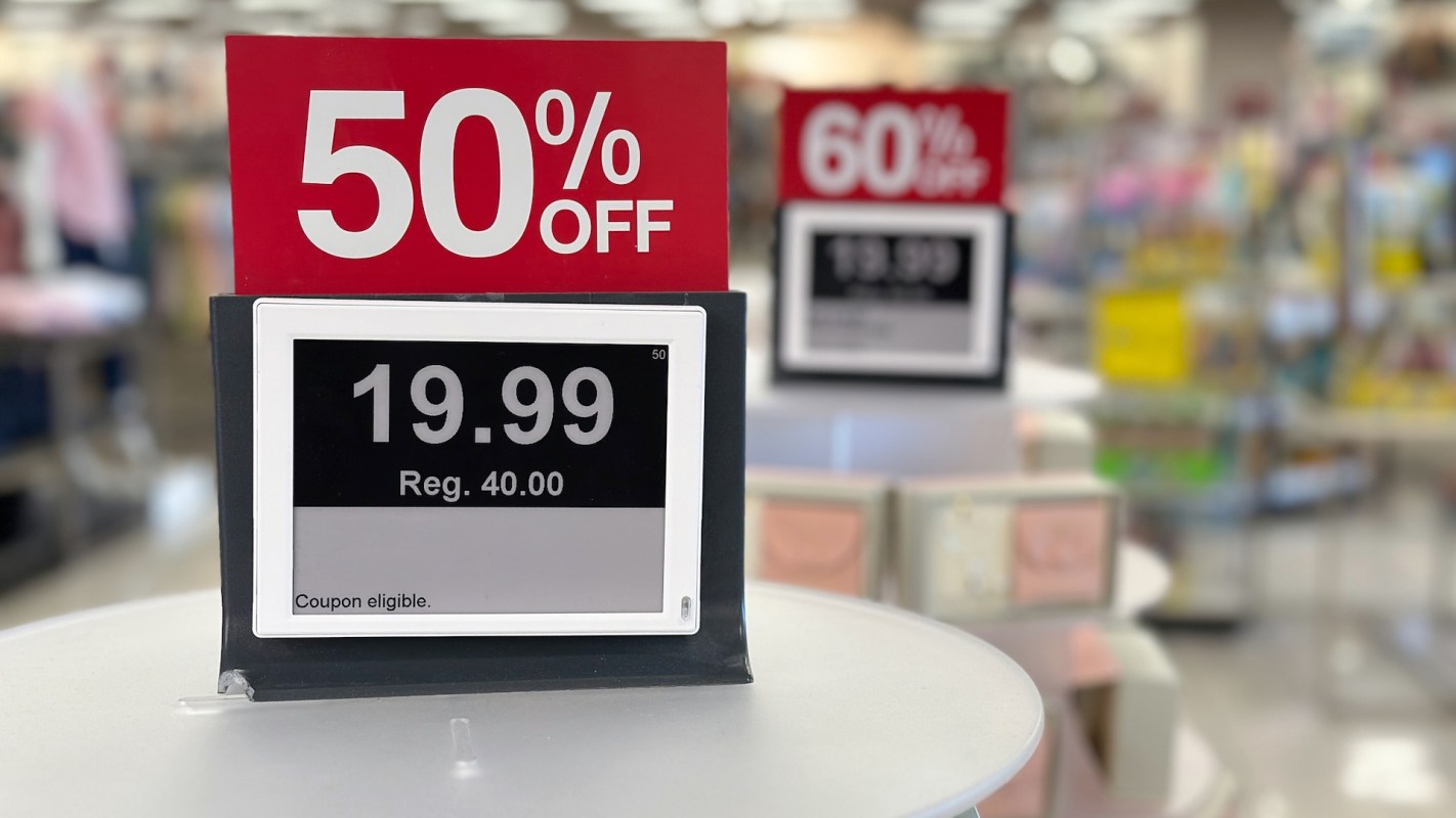 A retail display showing an electronic sign for 50% off an item priced at $19.99, originally $40.