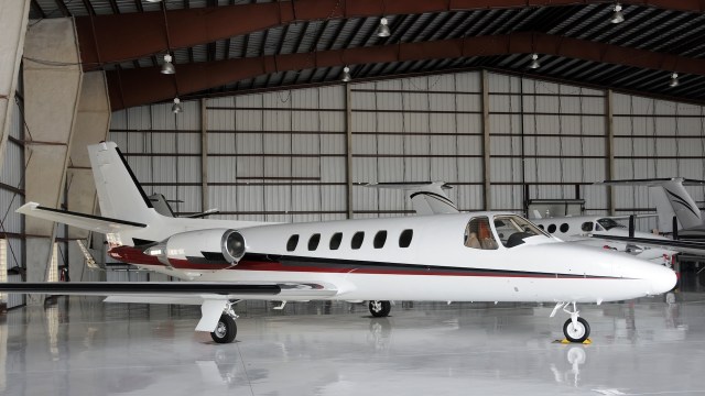 A private jet parked inside a hangar.