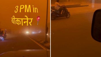 A hazy street scene in Bikaner, India, at 3 PM with poor visibility due to dust.