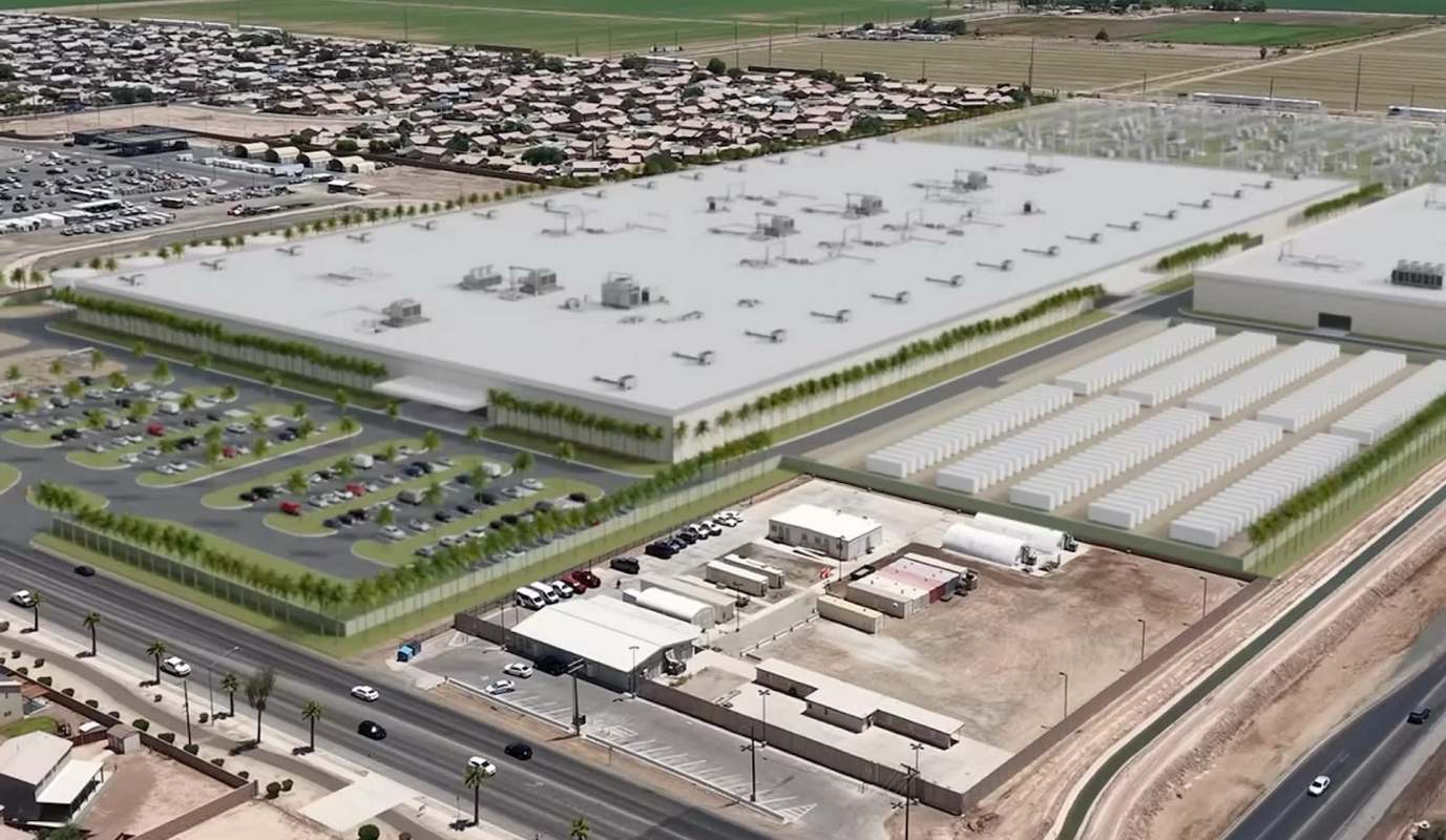 An aerial view of a large industrial facility surrounded by parking lots and nearby residential areas.
