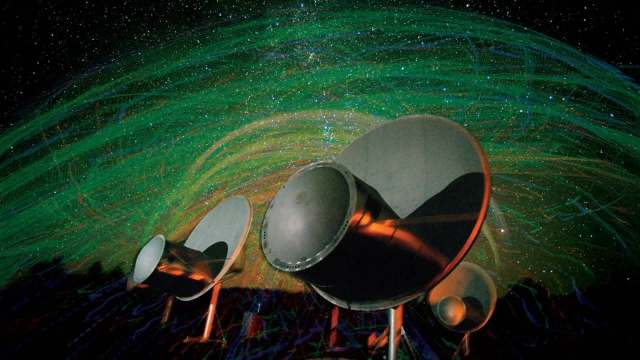 Three large satellite dishes are set against a colorful starry background with swirling green and blue patterns.