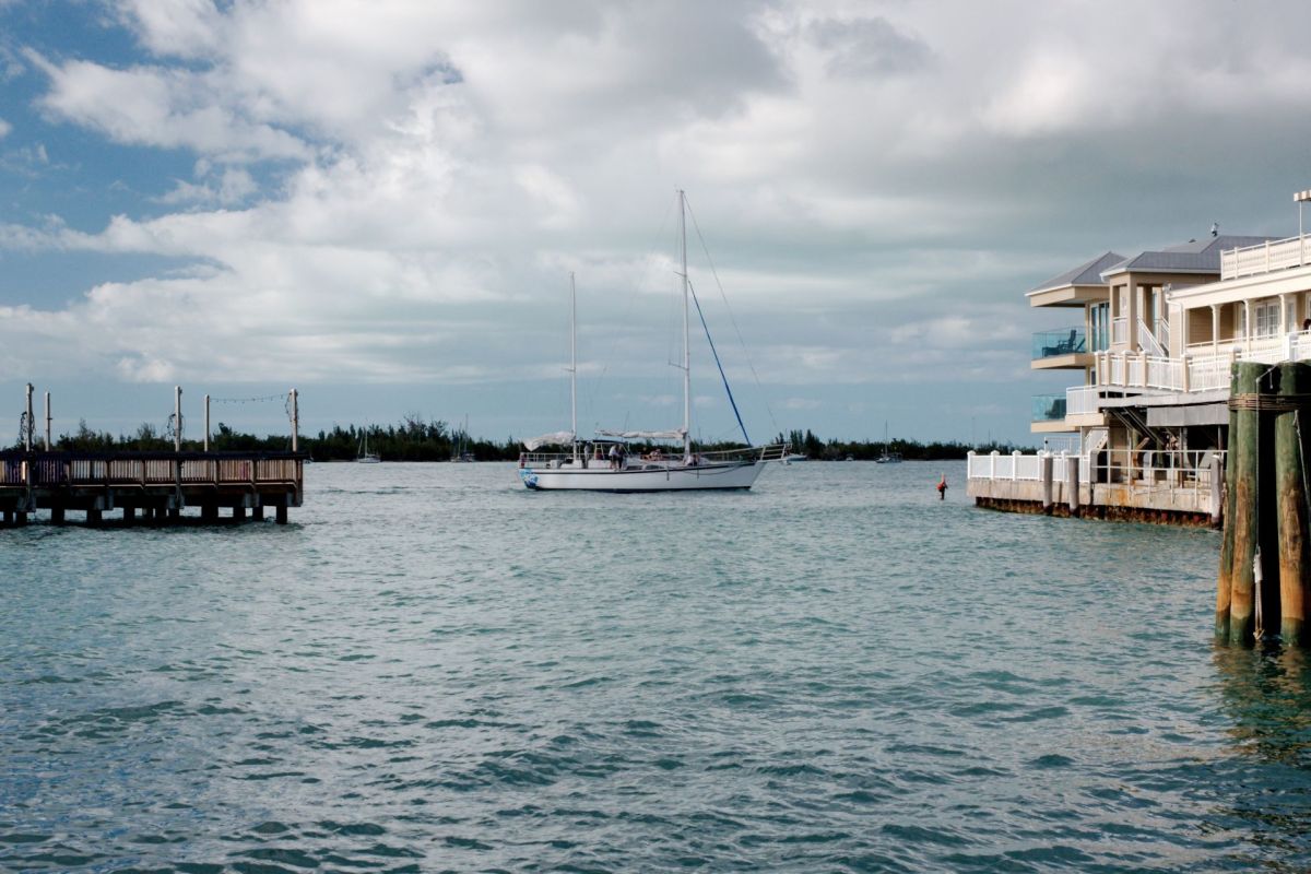 A boat on the water next to a dock in Key West, Florida.