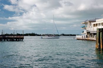 A boat on the water next to a dock in Key West, Florida.