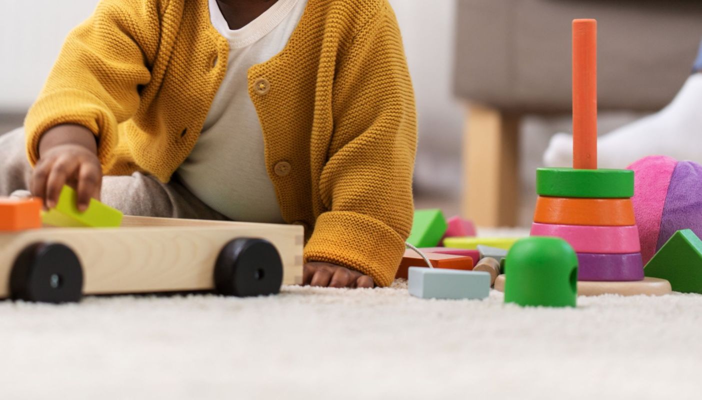 A kid playing with toys.