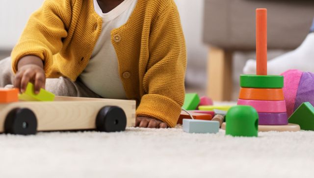 A kid playing with toys.