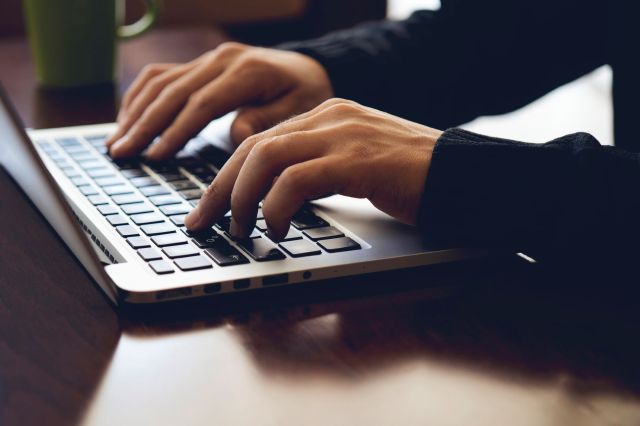 A person typing on a laptop.