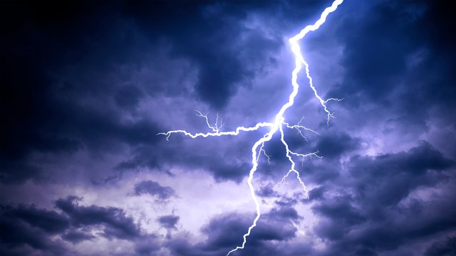A dramatic lightning bolt strikes through dark, stormy clouds.