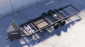 A top view of a PowerSled trailer showing its frame, wheels, and internal components.