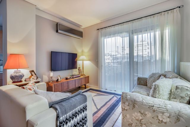 A living room with a mini split in the corner.