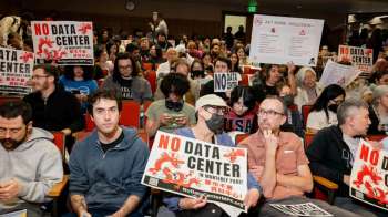 People with signs that call for a data center ban in Monterey Park.