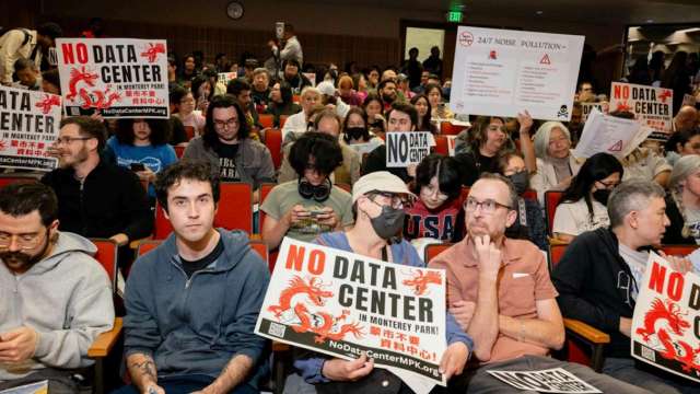 People with signs that call for a data center ban in Monterey Park.