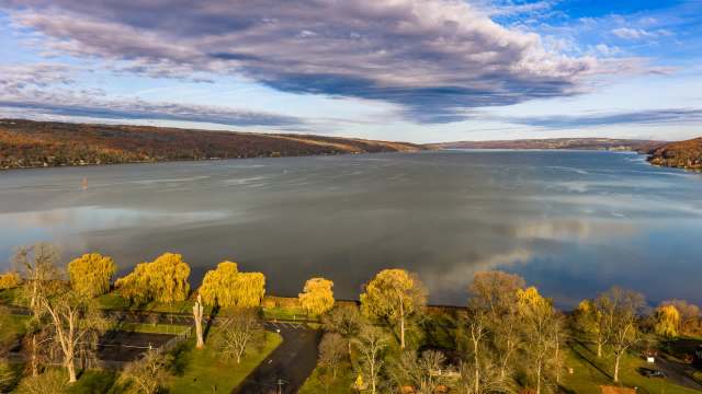 A tranquil lake surrounded by autumn foliage.