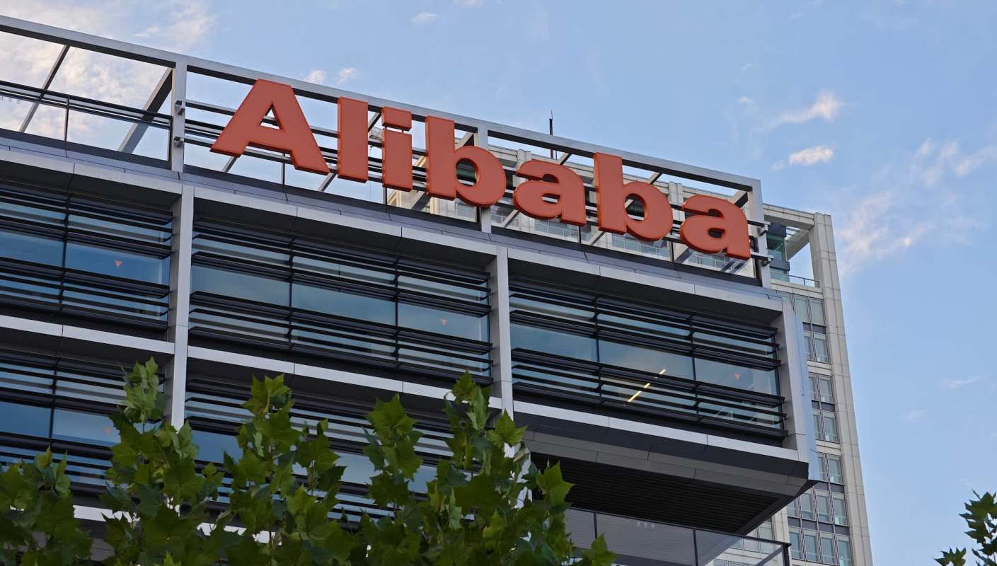 A close-up view of an Alibaba logo on a modern building.