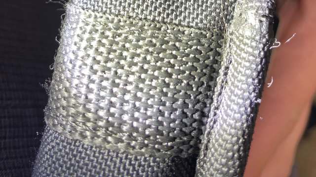 A close-up view of textured gray fabric showcasing its woven pattern and shine.