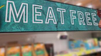 A sign reading "Meat Free" displayed in a grocery store.