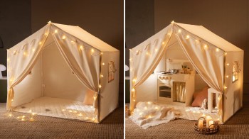 A children's tent with fairy lights, featuring a play kitchen inside and a quilted floor mat.